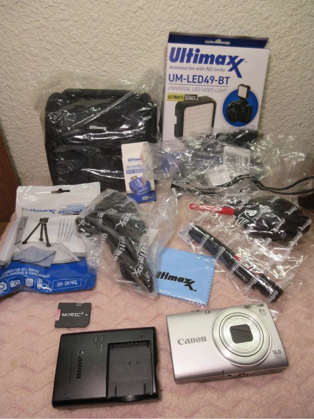 Canon Silver Compact Camera with Black Charger and Accessories